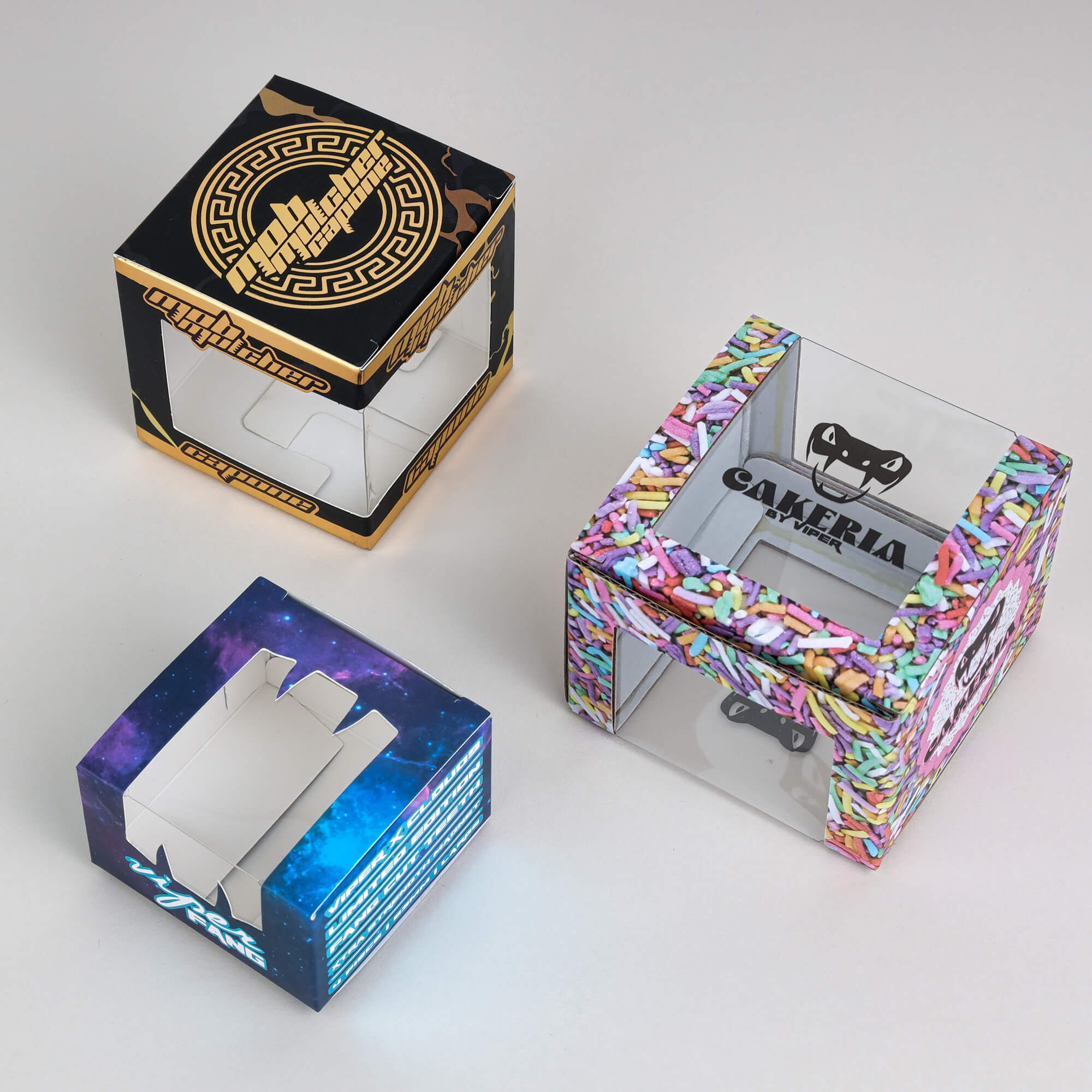 Three folding boxes with PET clear film windows to showcase products inside