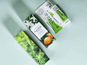 Closed white cardboard box with Botanicanon logo in green, displayed on white surface